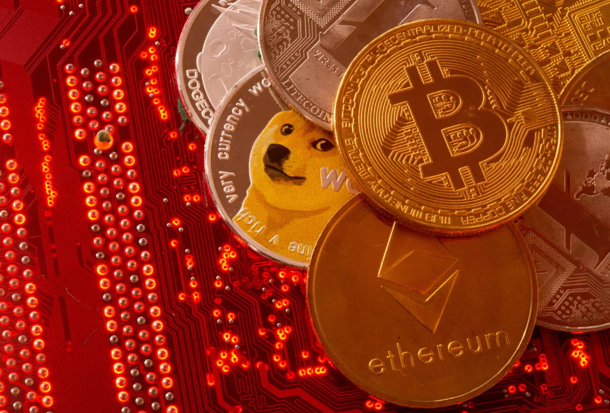 Bitcoin, Ethereum, DogeCoin, Ripple, Litecoin are placed on PC motherboard, on June 29, 2021. (Dado Ruvic/Reuters)