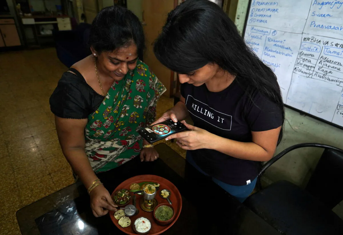 Geetha Sridha, 54, makes a video with her daughter Sarada Sridhar, that will upload on an Indian short video app, in Mumbai, India, on July 1, 2020. (Hemanshi Kamani/Reuters)
