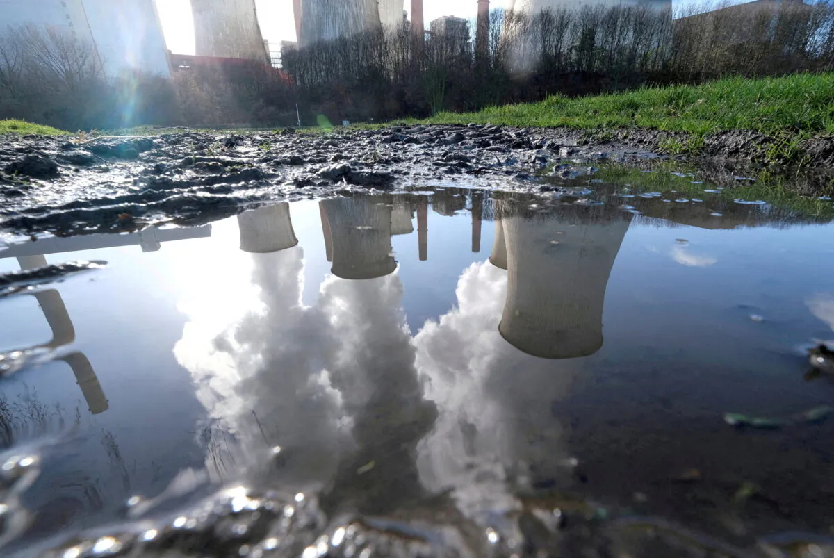 The lignite (brown coal) power plant complex of German energy supplier and utility RWE is reflected in a large puddle in Neurath, northwest of Cologne, Germany, on Feb. 5, 2020. (Wolfgang Rattay/Reuters)