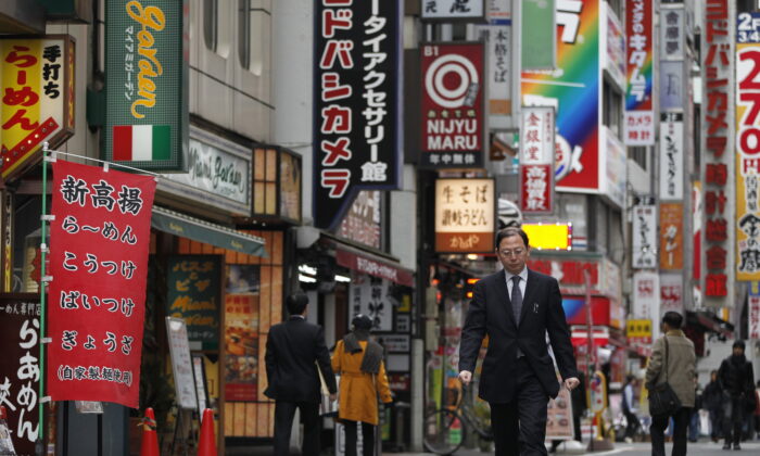 A man walks through a street in Tokyo's Shinjuku district on March 8, 2012. (Yuriko Nakao/Reuters)