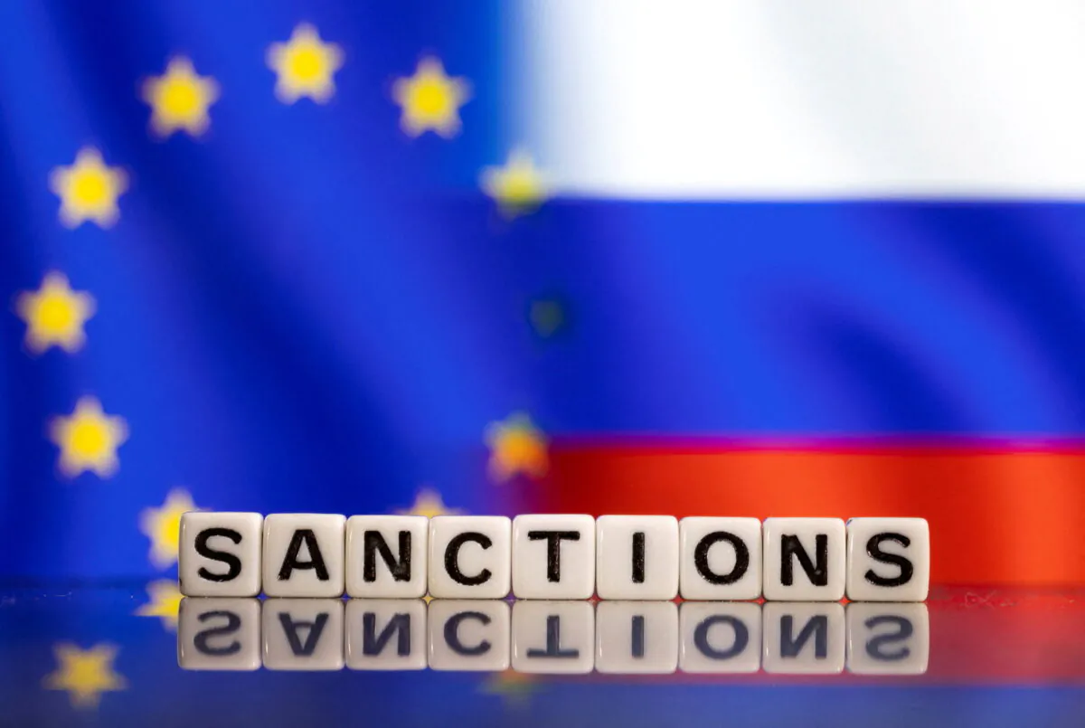 Plastic letters arranged to read "sanctions" are placed in front of EU and Russia's flag colors in this illustration taken on Feb. 25, 2022. (Dado Ruvic/Illustration/Reuters)  