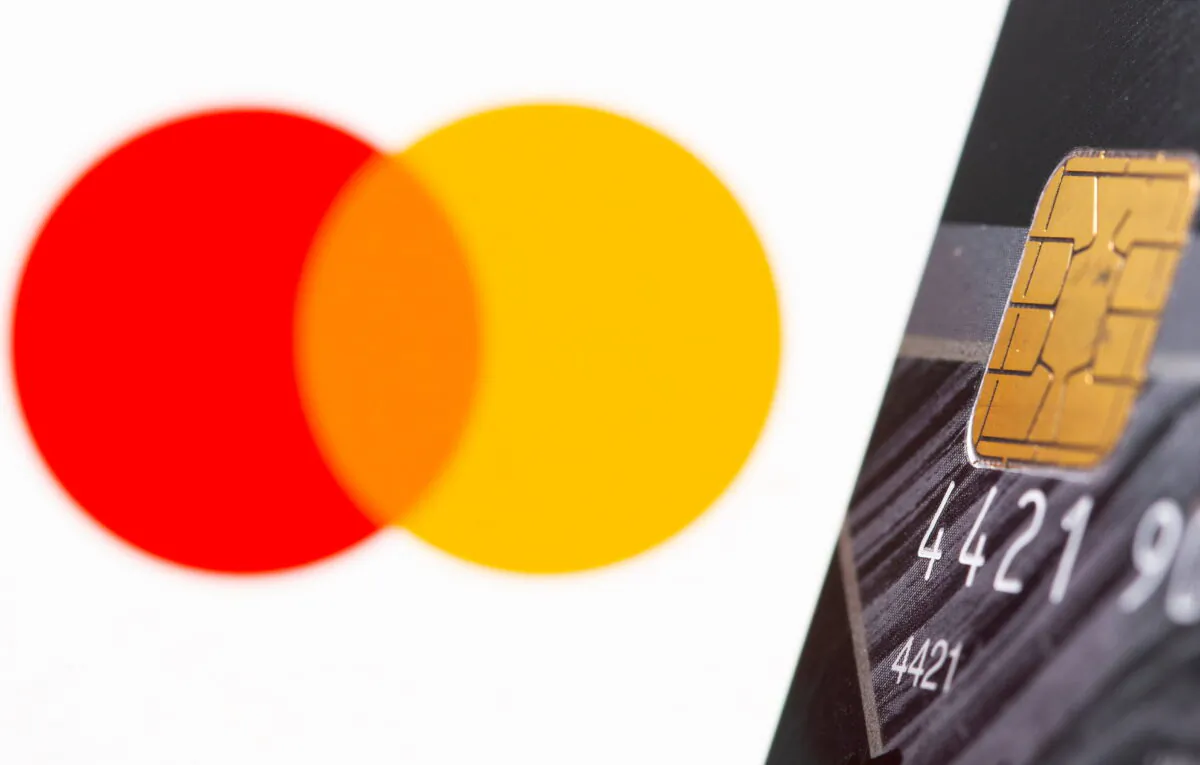 Credit card is seen in front of displayed Master Card logo in this illustration taken, July 15, 2021. (Dado Ruvic/Illustration/File Photo/Reuters)