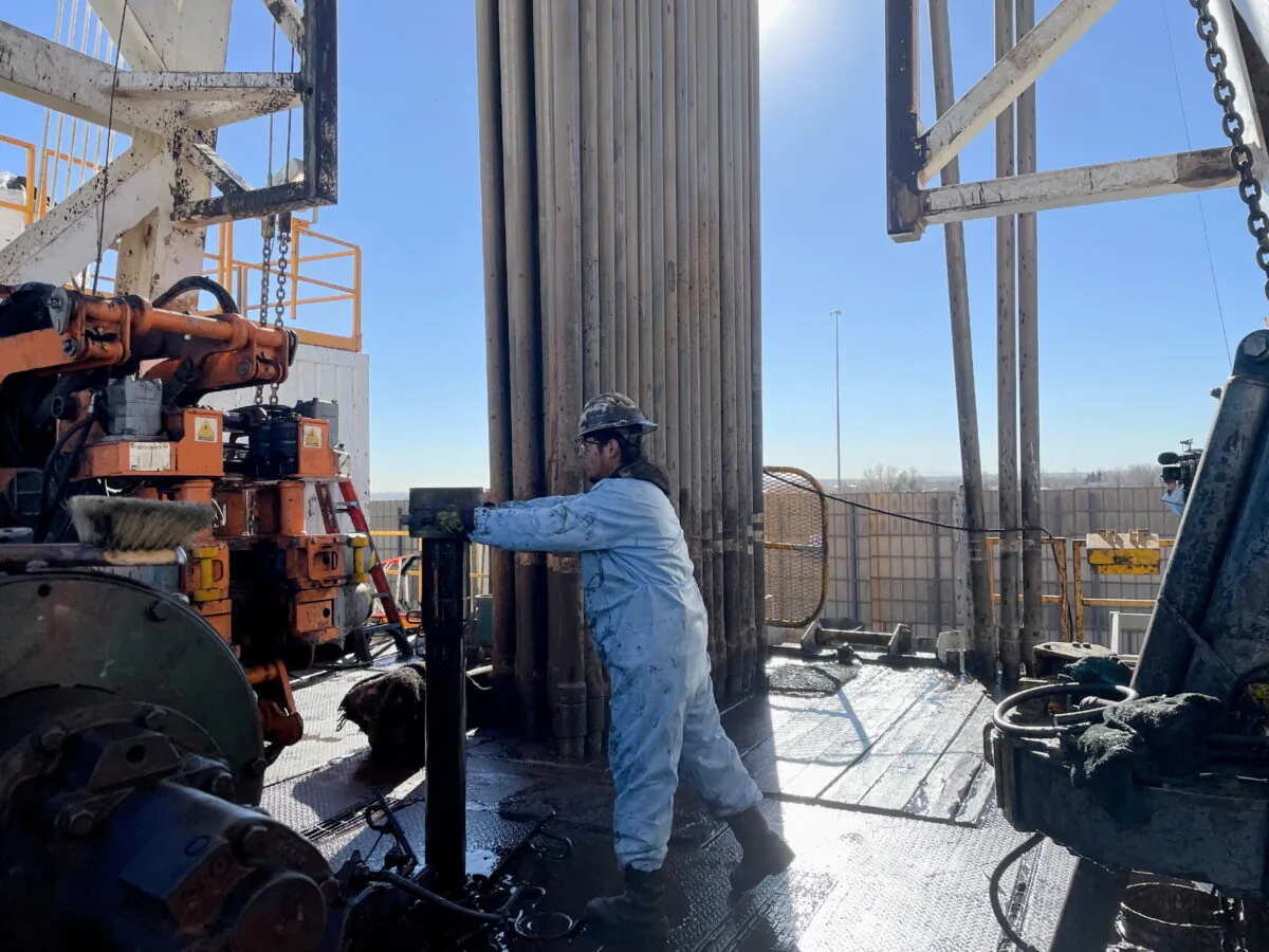 A rig hand works on an electric drilling rig for oil producer Civitas Resources, at the Denver suburbs, in Broomfield, Colo., on Dec. 2, 2021. (Liz Hampton/Reuters)