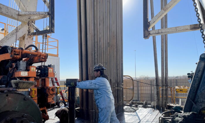 A rig hand works on an electric drilling rig for oil producer Civitas Resources, at the Denver suburbs, in Broomfield, Colo., on Dec. 2, 2021. (Liz Hampton/Reuters)