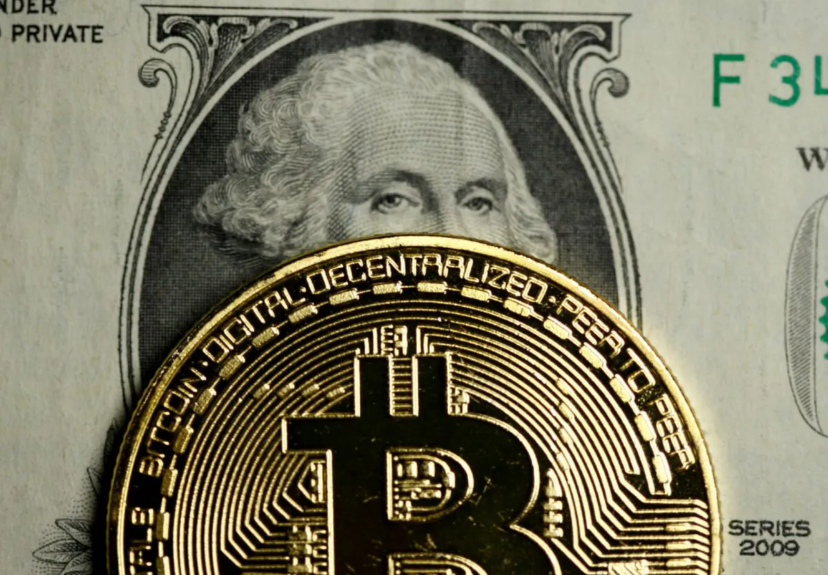 A Bitcoin and Dollar note are seen in this illustration picture taken on Sept. 27, 2017. (Dado Ruvic/REUTERS)