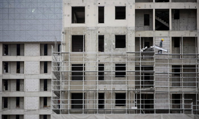 A worker walks on scaffolding at a construction site in Shanghai, on Jan. 14, 2022. (Aly Song/Reuters)