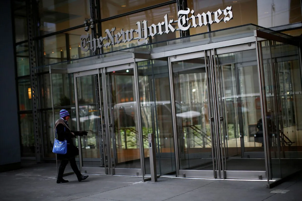 A woman walks into the New York Times building in New York on Feb. 7, 2013. (Eric Thayer/Reuters)