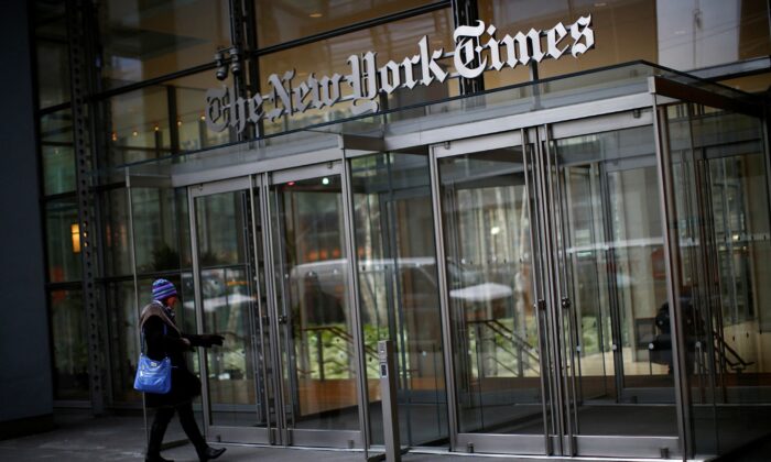 A woman walks into the New York Times building in New York on Feb. 7, 2013. (Eric Thayer/Reuters)