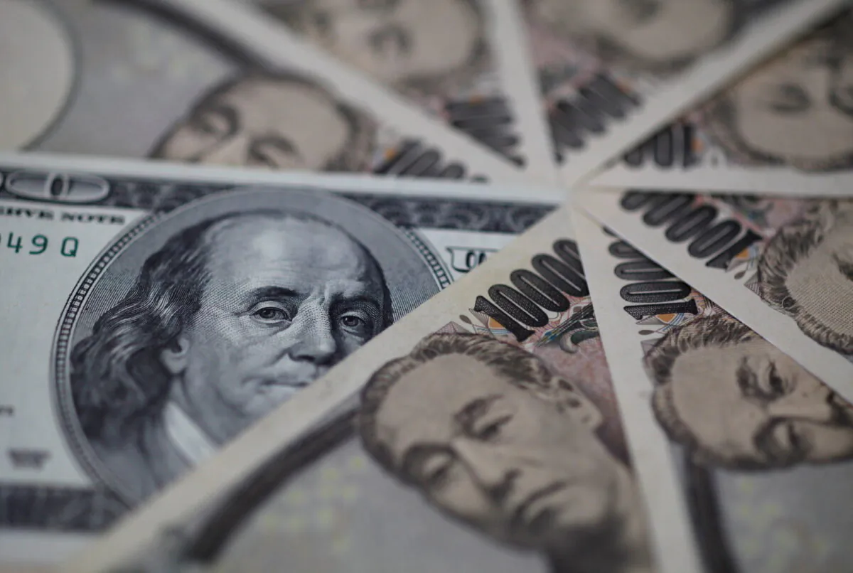 A U.S. hundred dollar bill and Japanese 10,000 yen notes are seen in this photo illustration in Tokyo, Japan, on Feb. 28, 2013. (Shohei Miyano/Reuters)