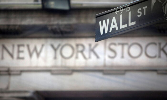 A Wall Street sign is pictured outside the New York Stock Exchange in New York, on Oct. 28, 2013. (Carlo Allegri/Reuters)