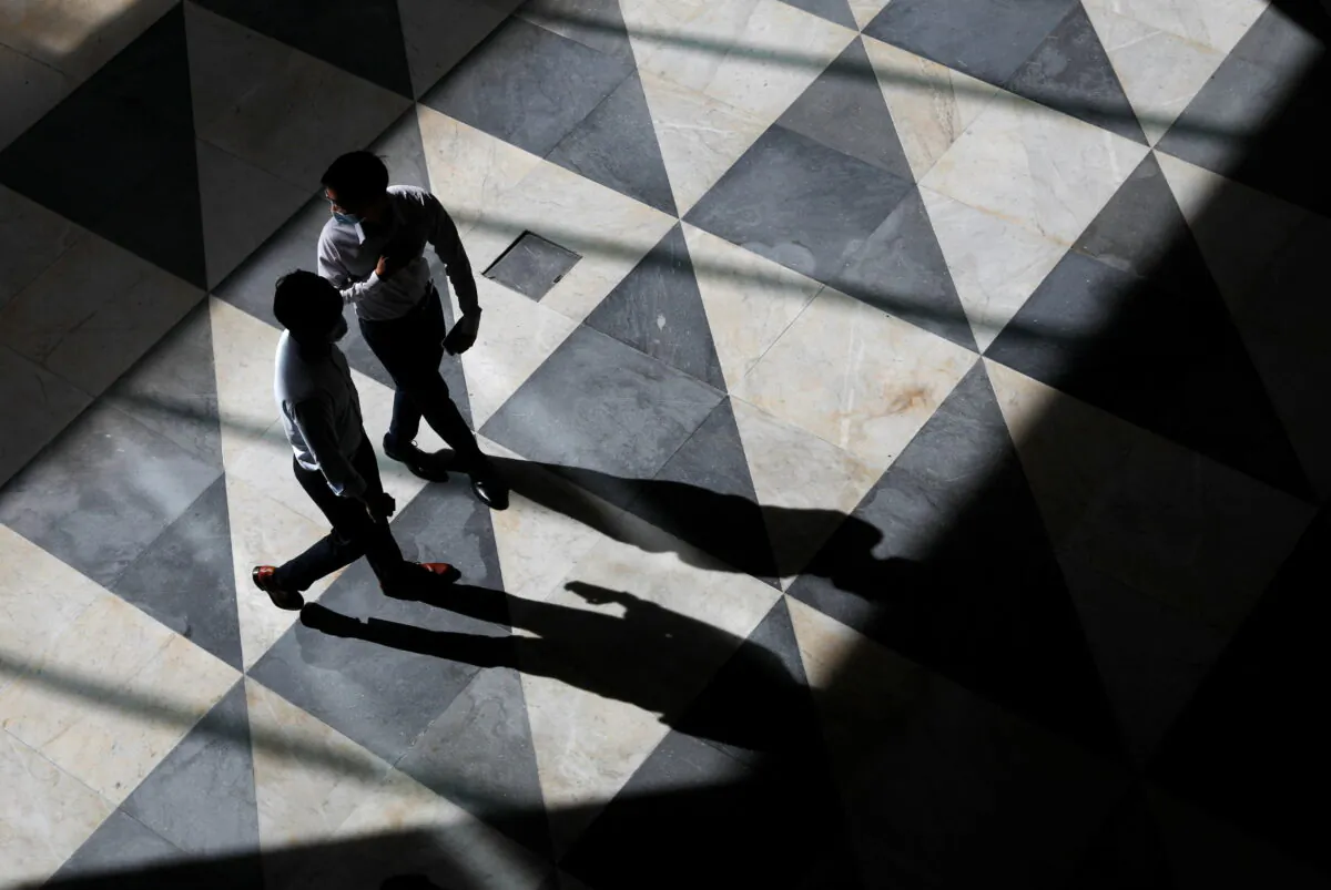 Office workers at a largely empty central business district in Singapore on Sept. 27, 2021. (Edgar Su/Reuters)