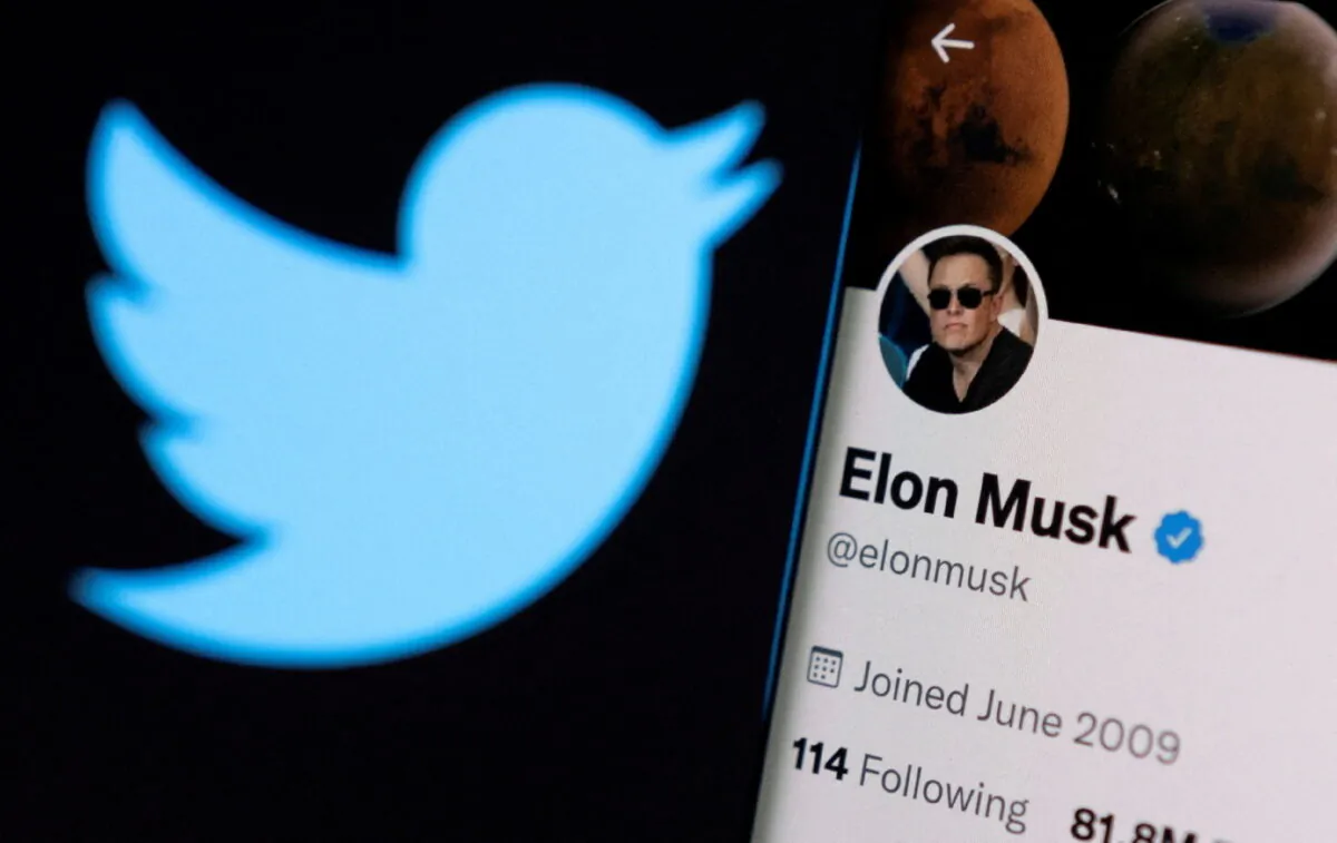 Elon Musk's twitter account is seen on a smartphone in front of the Twitter logo in this photo illustration taken on April 15, 2022. (Dado Ruvic/Reuters)