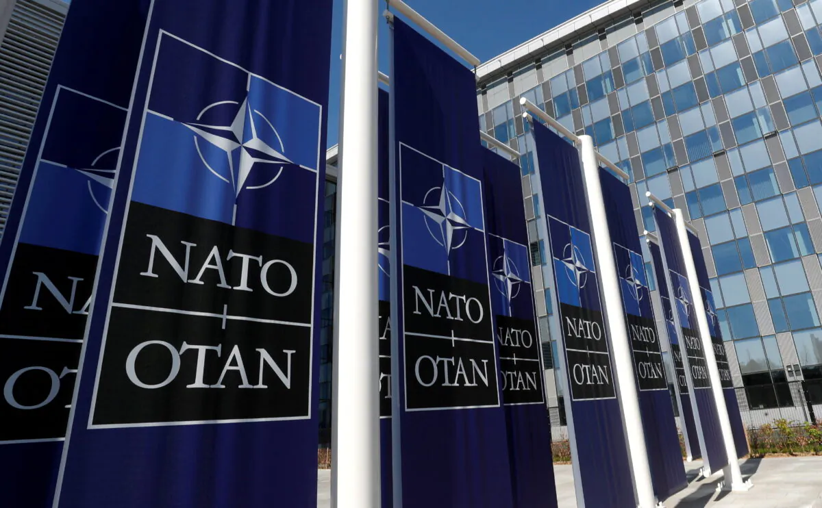 Banners displaying the NATO logo are placed at the entrance of new NATO headquarters during the move to the new building, in Brussels on April 19, 2018. (Yves Herman/Reuters)