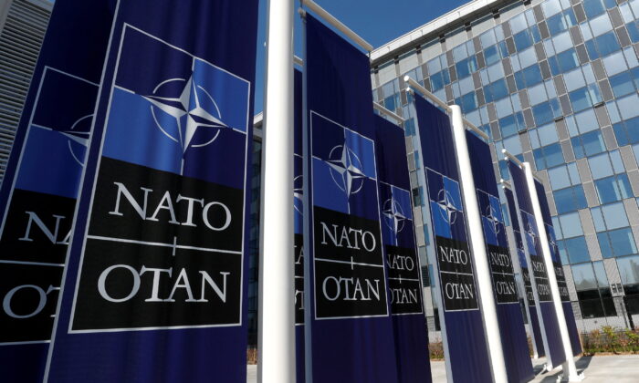Banners displaying the NATO logo are placed at the entrance of new NATO headquarters during the move to the new building, in Brussels on April 19, 2018.  (Yves Herman/Reuters)