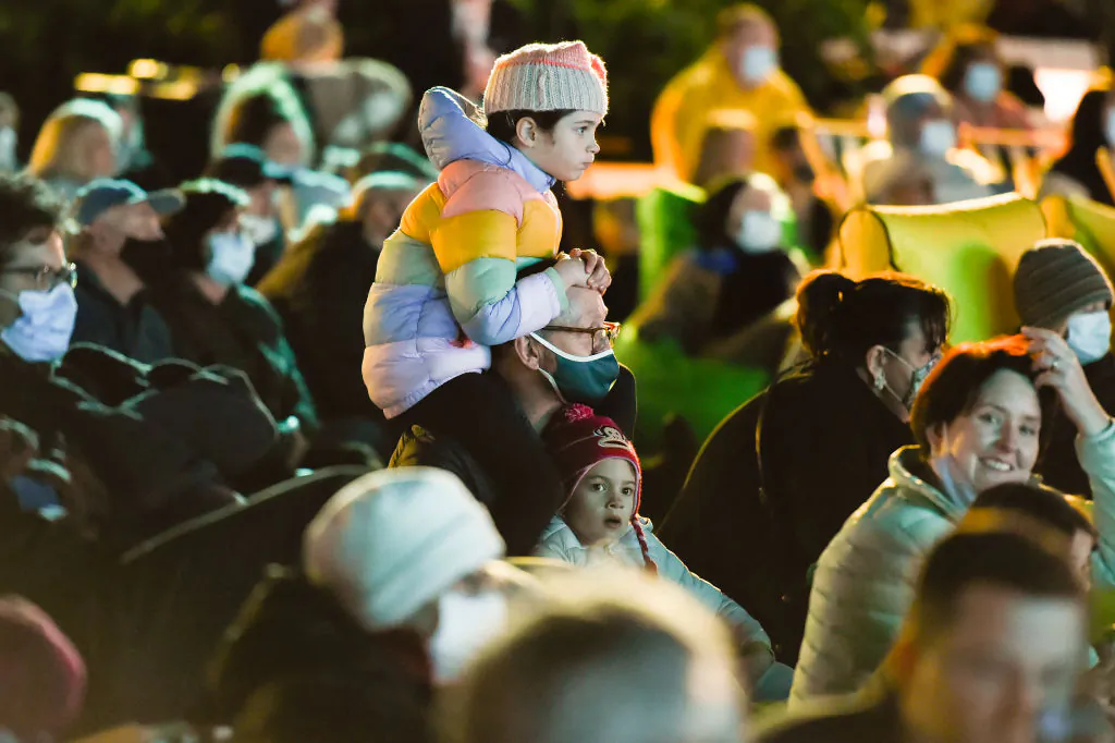 Members of the public watch on as they await the outcome from the vote to decide the 2032 Olympics host, watched via live feed in Tokyo, at the Brisbane Olympic Live Site in Brisbane, Australia, on July 21, 2021. (Albert Perez/Getty Images)