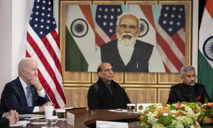 (L–R) U.S. President Joe Biden, Indian Minister of Defense Rajnath Singh, and Indian Foreign Minister Subrahmanyam Jaishankar listen as Prime Minister of India Narendra Modi (on screen) speaks during a virtual meeting in the South Court Auditorium of the White House complex on April 11, 2022. (Drew Angerer/Getty Images)