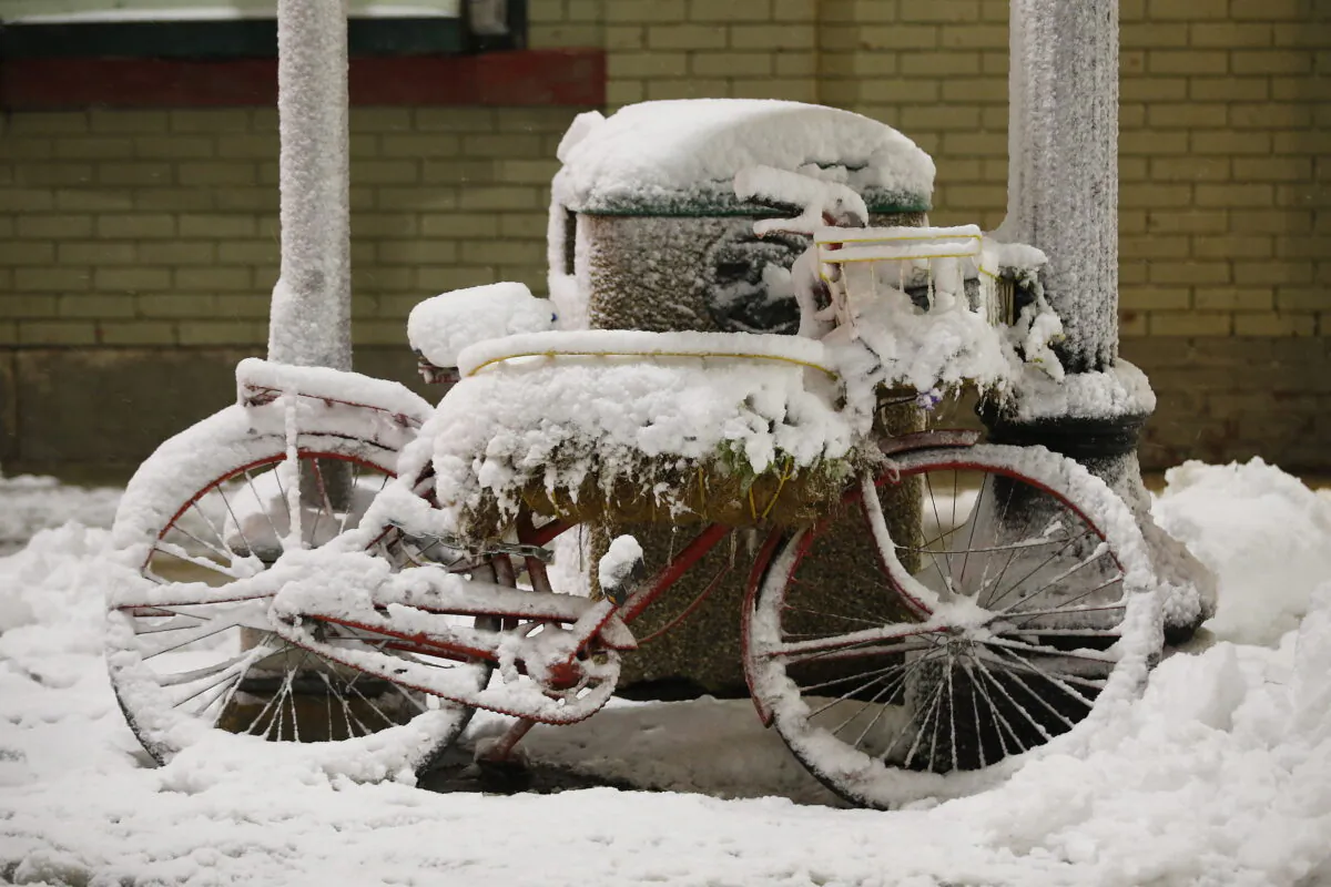A bicycle sits covered in snow during a winter storm which caused caused fallen trees and power lines in Winnipeg on October 11, 2019. Environment Canada says a snowstorm that is approaching southern Manitoba this week may be the worst blizzard in decades. (The Canadian Press/John Woods)