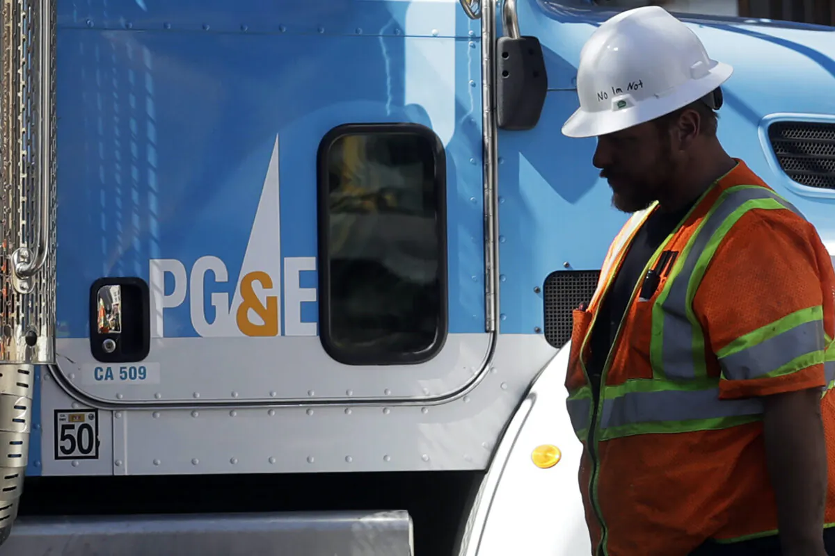 A Pacific Gas & Electric worker walks in front of a truck in San Francisco, on Aug. 15, 2019. (Jeff Chiu/AP Photo)