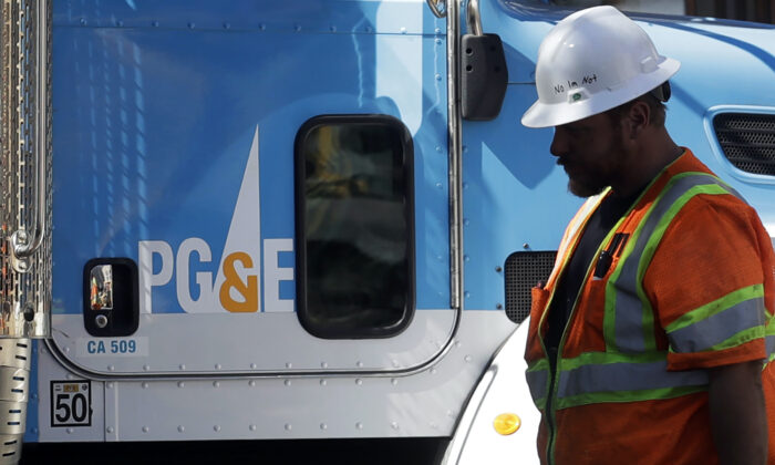 A Pacific Gas & Electric worker walks in front of a truck in San Francisco, on Aug. 15, 2019. (Jeff Chiu/AP Photo)