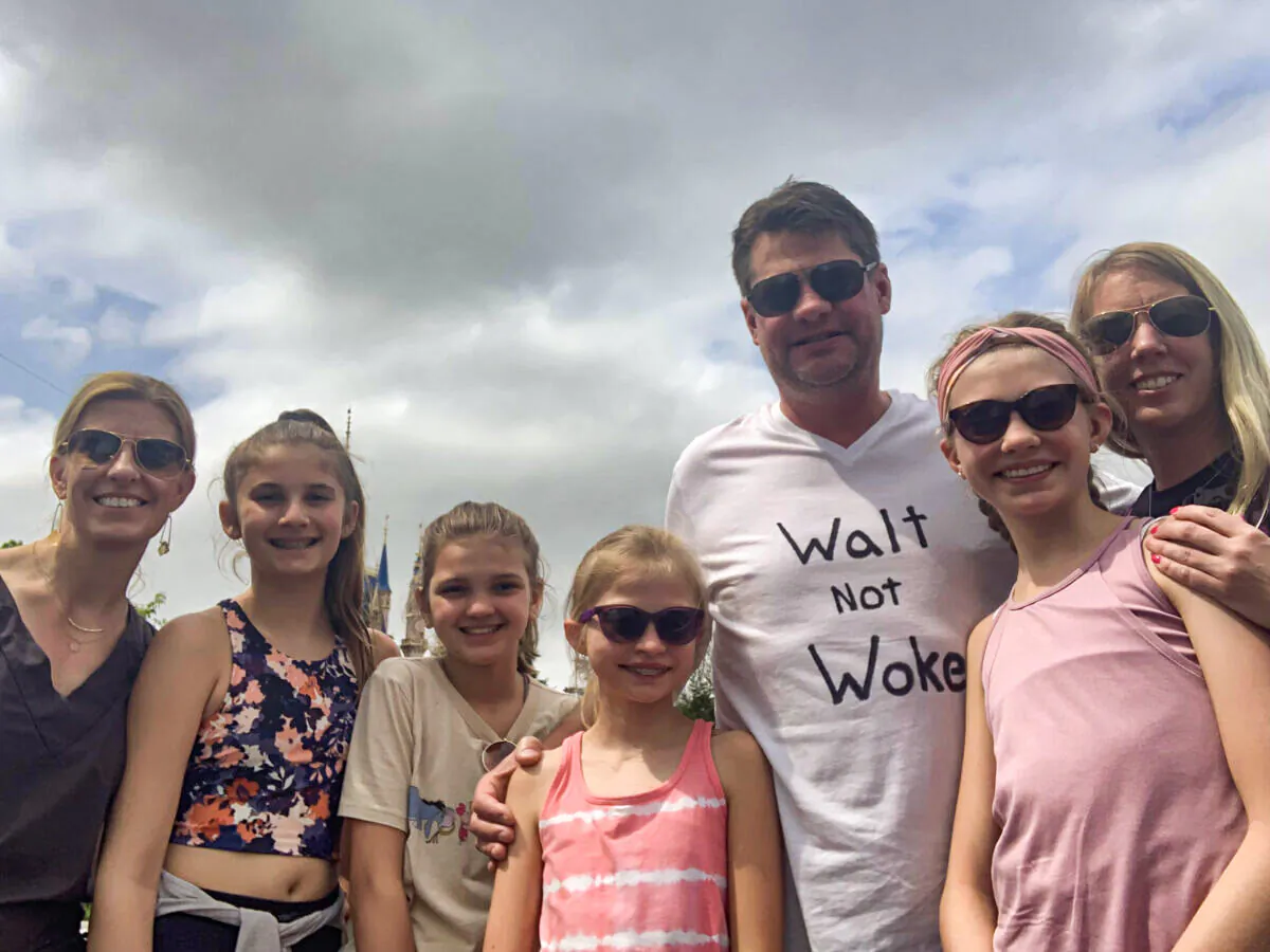 (L–R) Michelle Depa, Allison Stromske, Halle Nebl, Bryn Geffers, Dan Geffers, Lila Geffers, and Amy Geffers pose for a photo at Disney's Magic Kingdom. (Courtesy of Dan Geffers)