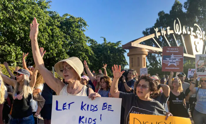 Protestors rally in opposition to The Walt Disney Company's stance against a recently passed Florida law outside of the company's headquarters in Burbank Calif., on April 6, 2022. (Jill McLaughlin/The Epoch Times)