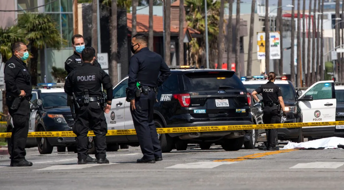 LAPD police officers stand in Los Angeles, on April 24, 2021. (Valerie Macon/AFP via Getty Images)