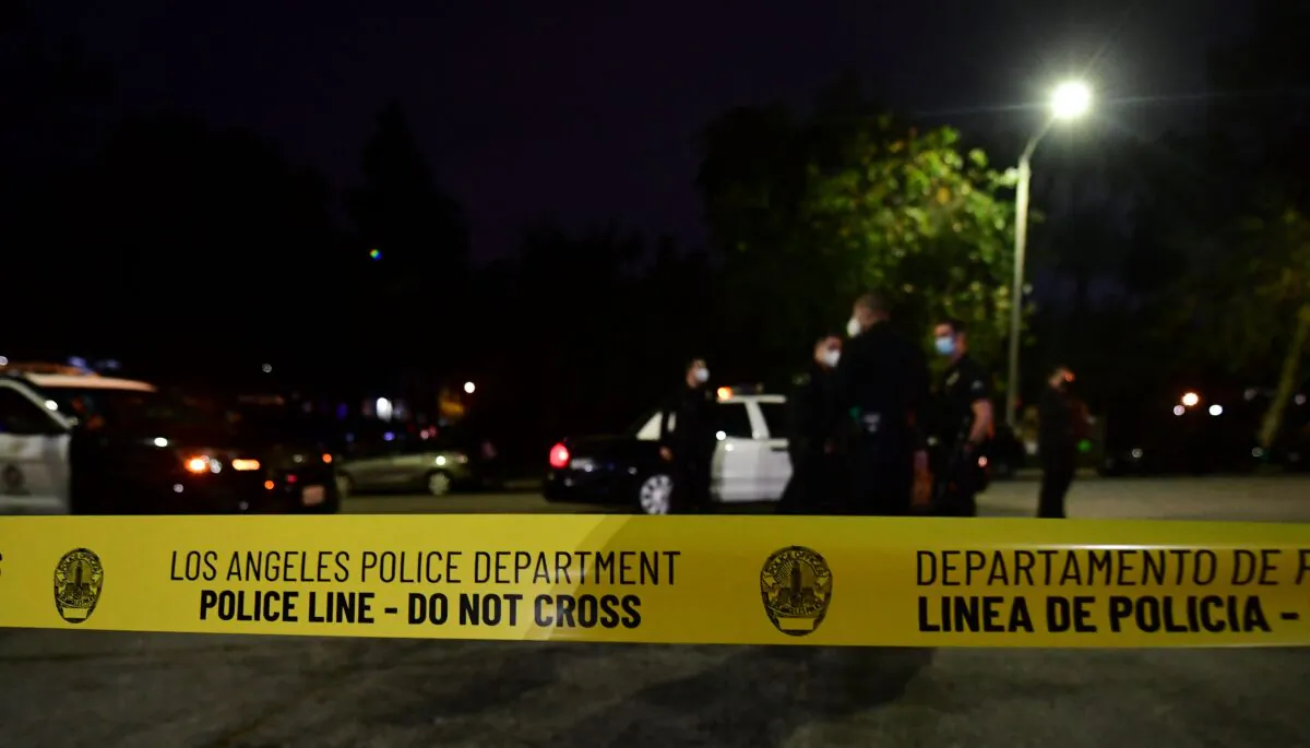 Police tape closes off a street in Los Angeles on March 24, 2021. (Frederic J. Brown/AFP via Getty Images)