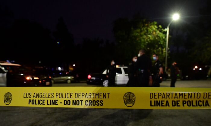 Police tape closes off a street in Los Angeles, on March 24, 2021. (Frederic J. Brown/AFP via Getty Images)
