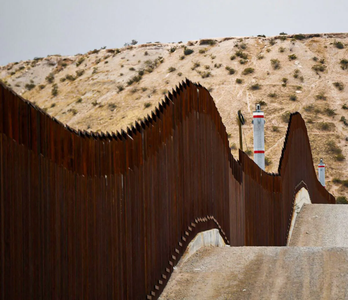 A US Border Patrol vehicle sits next to a border wall in the El Paso Sector along the U.S.-Mexico border between New Mexico and Chihuahua state,  in Sunland Park, New Mexico, on Dec. 9, 2021. (Patrick T. Fallon/AFP via Getty Images)