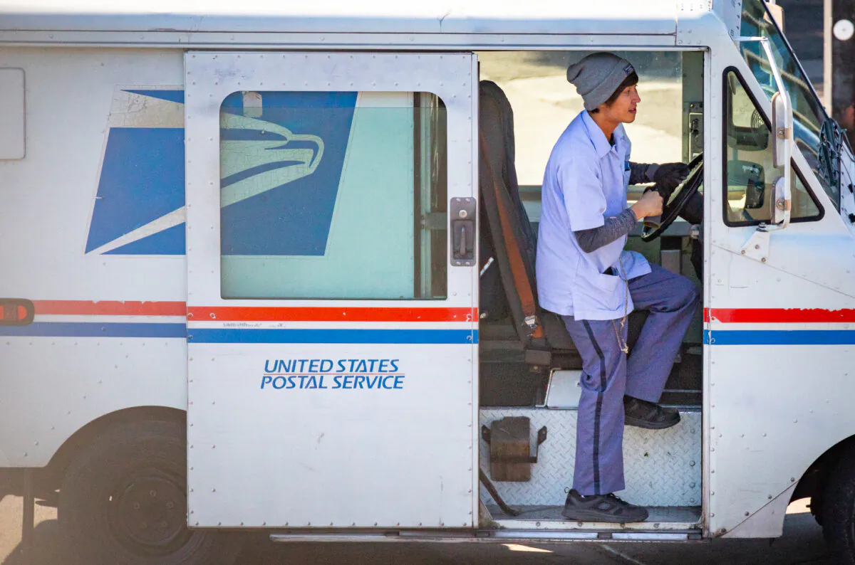 A USPS mail carrier prepares for a shift in Los Angeles on Jan. 21, 2022. (John Fredricks/The Epoch Times)