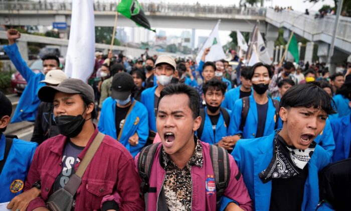 Students shout slogans during a rally outside the parliament in Jakarta, Indonesia, on April 11, 2022. (Dita Alangkara/AP Photo)