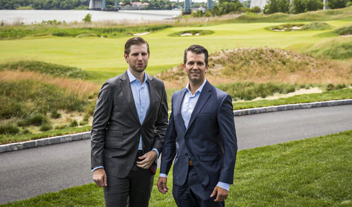 Eric Trump (L) and Donald Trump Jr. pose for photos during a ribbon cutting event for a new clubhouse at Trump Golf Links at Ferry Point in the Bronx borough of New York, on June 11, 2018. (Drew Angerer/Getty Images)