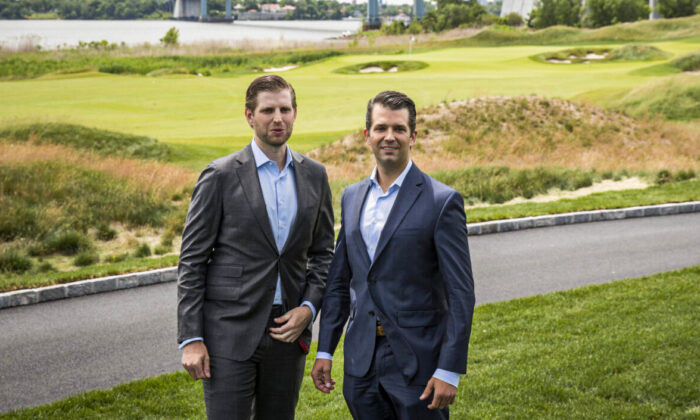Eric Trump (L) and Donald Trump Jr. pose for photos during a ribbon cutting event for a new clubhouse at Trump Golf Links at Ferry Point in the Bronx borough of New York, on June 11, 2018. (Drew Angerer/Getty Images)