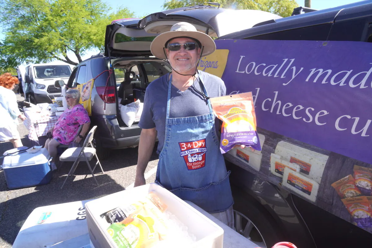 Tom Garrett, also known as The Cheese Guy, was one of many vendors selling locally sourced food and products at Sun City Farmers' Market in Sun City, Ariz., on April 7. (Allan Stein/The Epoch Times)