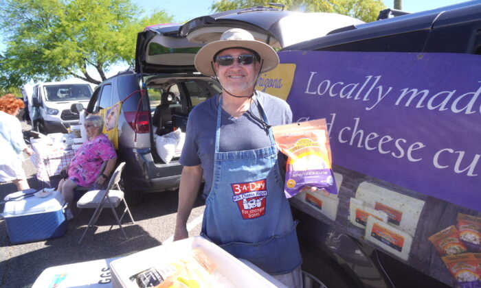 Tom Garrett, also known as The Cheese Guy, was one of many vendors selling locally sourced food and products at Sun City Farmers' Market in Sun City, Ariz., on April 7. (Allan Stein/The Epoch Times)