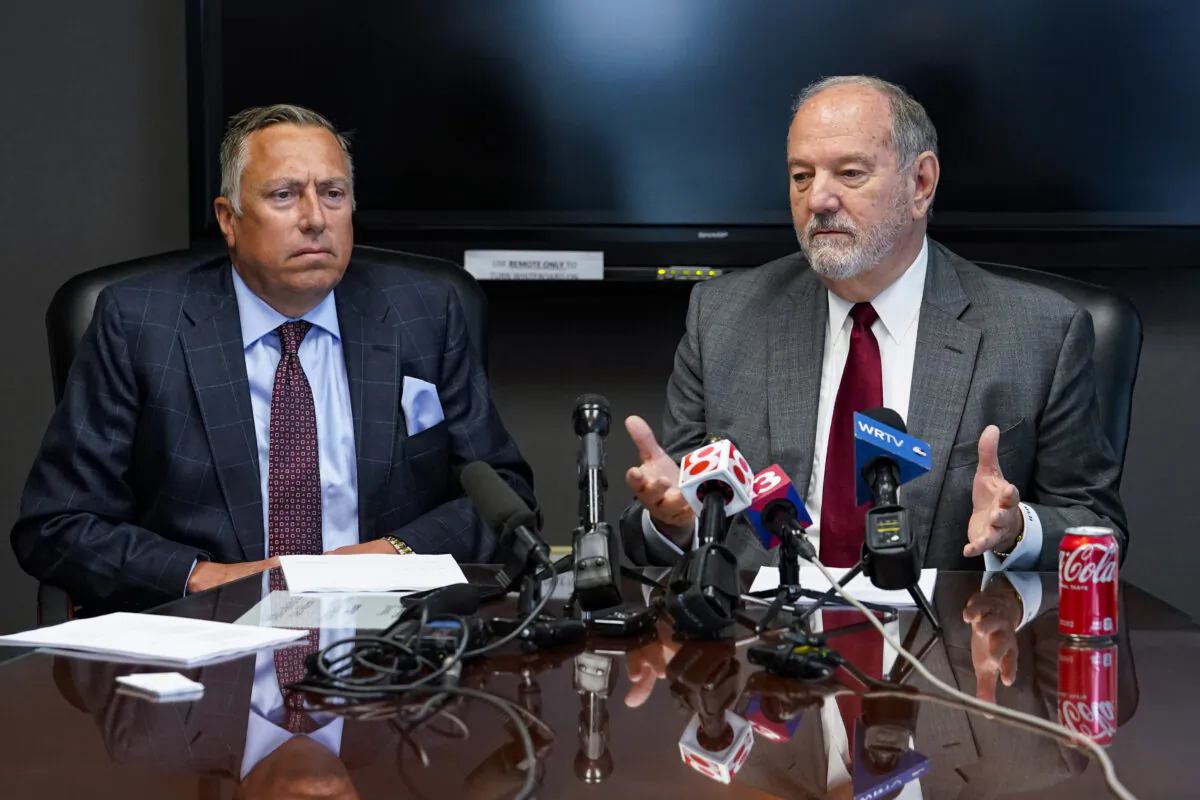 Attorneys Daniel Chamberlain, left, and Melvin Hewitt, Jr. announce a lawsuit in Indianapolis, Monday, April 11, 2022 on behalf of five families of the victims murdered in a mass shooting at the Indianapolis FedEx Ground facility on April 15, 2021. (Michael Conroy/AP Photo)