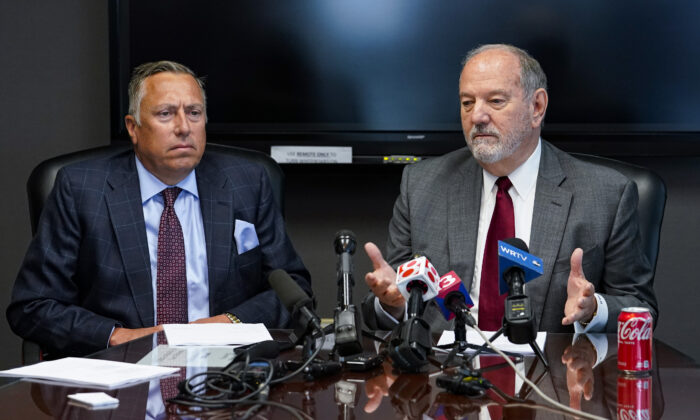 Attorneys Daniel Chamberlain, left, and Melvin Hewitt, Jr. announce a lawsuit in Indianapolis, Monday, April 11, 2022 on behalf of five families of the victims murdered in a mass shooting at the Indianapolis FedEx Ground facility on April 15, 2021. (Michael Conroy/AP Photo)