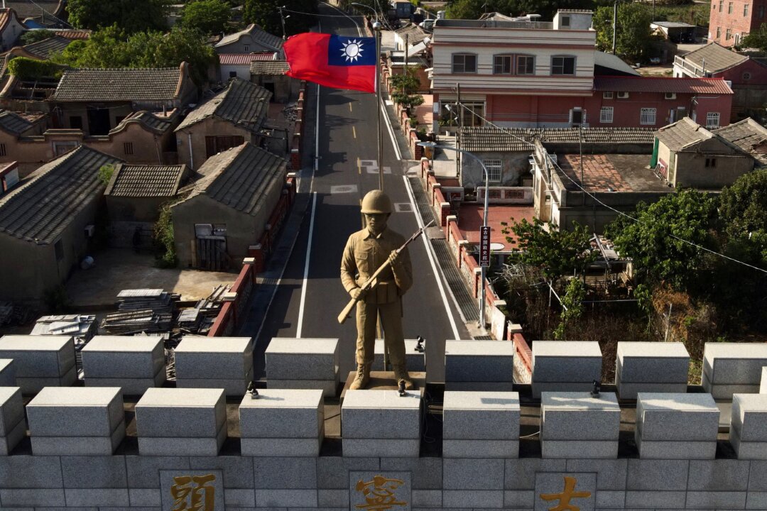 A military statue and Taiwanese flag on top of an arch built in remembrance of the Battle of Guningtou in 1949 at Taiwan's Kinmen islands, which lie just 2 miles from the mainland China coast in the Taiwan Strait, on Oct. 20, 2020. (Sam Yeh/AFP via Getty Images)