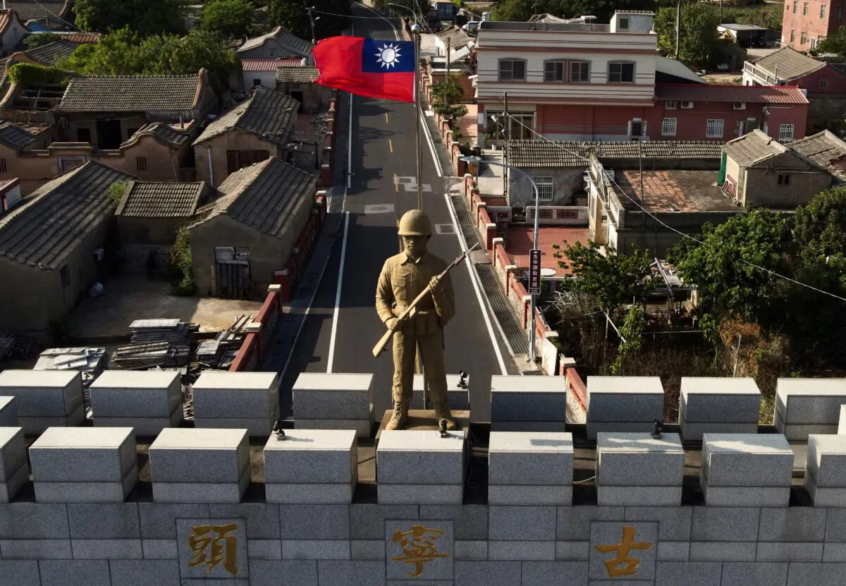 A military statue and Taiwanese flag atop  an arch built in remembrance of the Battle of Guningtou in 1949 at Taiwan's Kinmen islands on October 20, 2020. Kinmen islands lie just 3.2 kms (two miles) from the mainland China coast in the Taiwan Strait.(Sam Yeh/AFP via Getty Images)