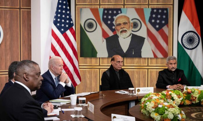 (L-R) U.S. Defense Secretary Lloyd Austin, U.S. President Joe Biden, Indian Minister of Defense Rajnath Singh, and Indian Foreign Minister Subrahmanyam Jaishankar listen as Prime Minister of India Narendra Modi (on screen) speaks during a virtual meeting in the South Court Auditorium of the White House complex in Washington on April 11, 2022. (Drew Angerer/Getty Images)