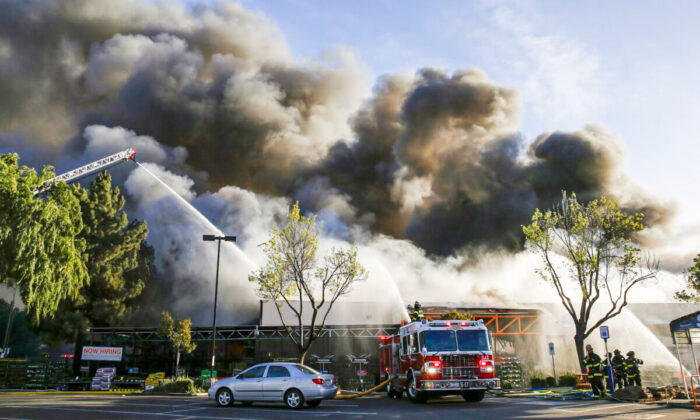 Firefighters work on a five-alarm fire at the Home Depot off Blossom Hill Road in San Jose, Calif., on April 9, 2022. (Shae Hammond/Bay Area News Group via AP)