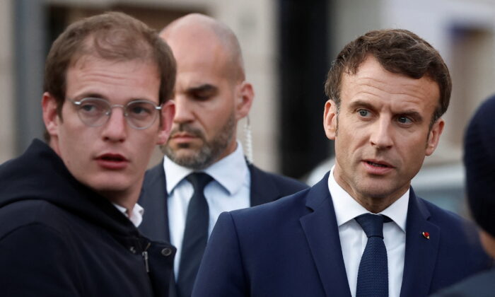French President Emmanuel Macron, candidate for his reelection, meets with supporters during his first campaign day trip after coming first in the first round of the 2022 French presidential election, in Carvin, France, on April 11, 2022. (Benoit Tessier/Pool via Reuters)