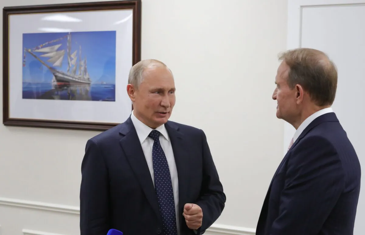 Russian President Vladimir Putin (L) speaks to Chairman of the political council of Ukrainian party "Opposition Platform—For Life" Viktor Medvedchuk (R) during the 5th Eastern Economic Forum in Vladivostok, Russia, on Sept. 5, 2019. (Mikhail Klimentyev/Sputnik/AFP via Getty Images)