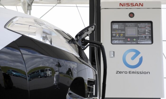 A prototype of Nissan Motors second generation electronic vehicle (EV) is hooked up to a quick charger, in Yokosuka, Kanagawa prefecture, south of Tokyo on July 27, 2009. (Toshifumi KitamuraI/AFP via Getty Images)