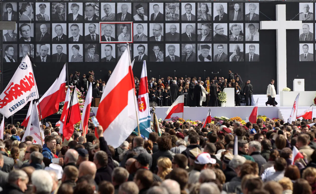 Mourners bear flags and standards while attending a memorial service for late Polish President Lech Kazcynski, his wife Maria and the 94 other people killed in a Polish presidential plane crash in Smolensk, Russia, at a memorial service at Pilsudski Square in Warsaw, Poland, on April 17, 2010. (Sean Gallup/Getty Images)