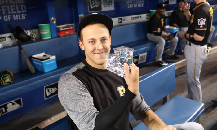Jameson Taillon, No.50 of the Pittsburgh Pirates holds up selected Topps baseball cards on National Baseball Card Day before the start of MLB game action against the Toronto Blue Jays at Rogers Centre on August 12, 2017 in Toronto, Canada. (Tom Szczerbowski/Getty Images)