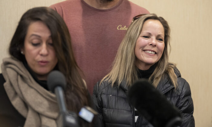 Tamara Lich (R), organizer of the Freedom Convoy protest by truckers and supporters demanding an end to COVID-19 vaccine mandates, smiles during a news conference in Ottawa, on Feb. 3, 2022. (Adrian Wyld/The Canadian Press)