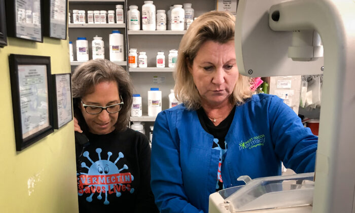 Donna Lowery (L) helps pharmacist Dawn Butterfield, owner of West Cocoa Pharmacy and Compounding, who's using automated pill counter to fill a prescription. (Courtesy of Donna Lowery)