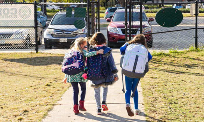 School children wearing masks walk outside Condit Elementary School in Bellaire, outside Houston, on Dec. 16, 2020. (Francois Picard/AFP via Getty Images)