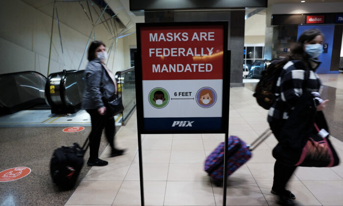 People walk through Sky Harbor International Airport in Phoenix, Ariz., on Dec. 18, 2021. (Spencer Platt/Getty Images)